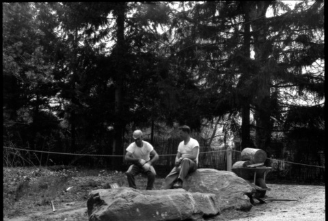 Two men sitting on large boulders (ddr-densho-377-1472)