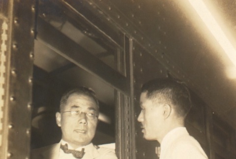 Shinzo Koizumi speaking to a man from a train window (ddr-njpa-4-484)