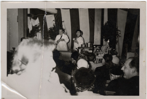 Man and woman doing cooking demonstration (ddr-densho-426-853)