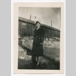 Henrietta Schoen posing in front of barracks (ddr-densho-223-10)