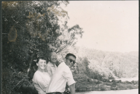 Chester Sakura Sr., with man and woman sitting on log (ddr-densho-523-334)