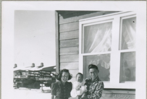 A family outside of a housing project apartment (ddr-densho-300-60)