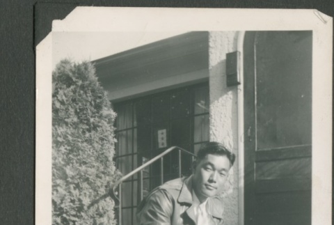 Masao Sakagami crouching on front steps (ddr-densho-328-41)