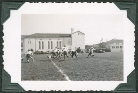Men playing football on field (ddr-densho-475-708)