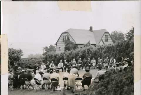 Photo of a large group meeting in a yard (ddr-densho-483-1381)