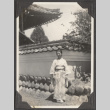 A woman standing in front of a building in Japan (ddr-densho-432-69)