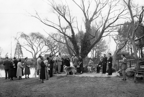 Group standing in garden with dog (ddr-ajah-3-25)