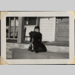 Boy with dog sitting on house steps (ddr-densho-466-908)