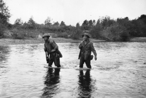Two men in uniform wading across river (ddr-ajah-2-750)