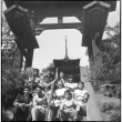Group sitting on stairs leading to tea garden in Golden Gate Park (ddr-densho-426-956)