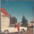 Woman standing next to car, man in driver's seat (ddr-densho-523-610)