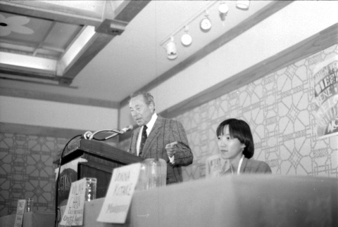 Stanley Diamond speaking, Wilma Chan at table (ddr-densho-1007-538)