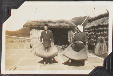 Man and woman processing rice (ddr-densho-326-323)