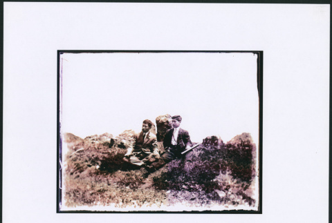 Two men sitting surrounded by rocks (ddr-densho-423-457)