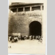 A crowd of adults and children gathered outside a building (ddr-njpa-6-15)