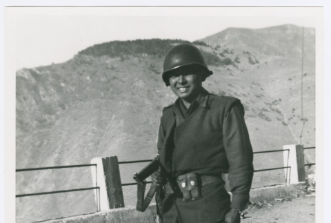 Serviceperson standing in front of fence (ddr-densho-1007-64)