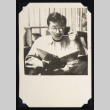 Eddie reading and smoking (ddr-densho-542-663)