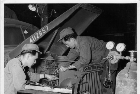 Nisei technicians repairing a truck (ddr-densho-114-68)