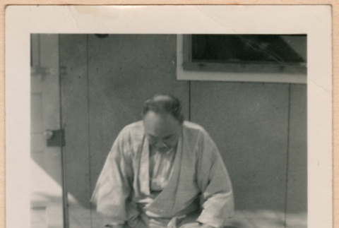 Man with Miki Domoto outside barracks (ddr-densho-329-1292)