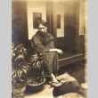 Man sitting in a courtyard (ddr-njpa-4-2578)