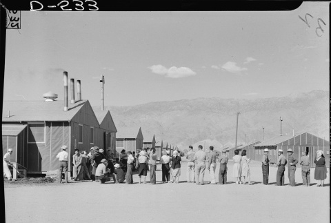 Japanese Americans waiting in line for mess hall (ddr-densho-37-812)