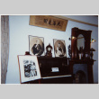 Display of photos, piano and fireplace surround (ddr-densho-426-576)
