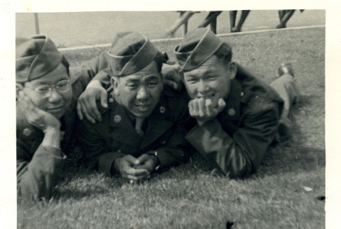 Three soldiers laying in a field (ddr-densho-22-282)