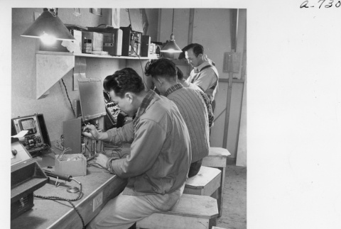 Men at work in the radio repair shop (ddr-fom-1-841)