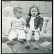 Photograph of children sitting on a bench at Manzanar (ddr-csujad-47-214)