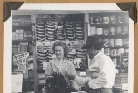 Woman helps a customer (ddr-densho-542-113)