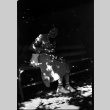 Woman sitting on bench feeding a squirrel (ddr-densho-426-1907)