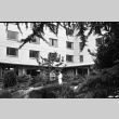 Two people talking in courtyard of Xavier Hall, Seattle University (ddr-densho-354-2065)