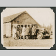 Group photo of seven people with a truck (ddr-densho-483-164)