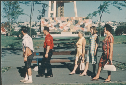 Five people walking past Mural stage at Seattle Center (ddr-densho-523-436)