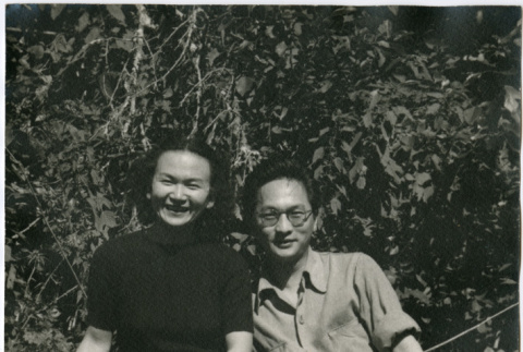 Man and woman sitting on log (ddr-densho-426-1066)