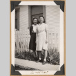 Two girls by a picket fence (ddr-densho-542-216)