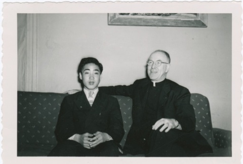 Priest and man sitting on couch (ddr-densho-330-289)