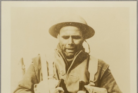 A soldier holding two smoke grenades [?] (ddr-njpa-13-1482)