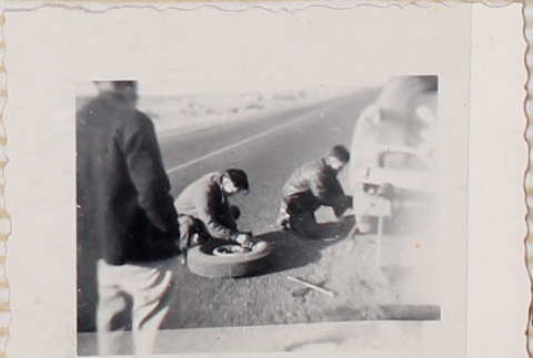 Three men changing a tire (ddr-densho-464-136)