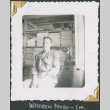 Man seated by supply shelves (ddr-densho-434-209)