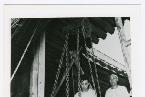 Men raising ancient bell (ddr-densho-1007-358)
