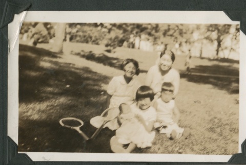 Family seated with tennis rackets (ddr-densho-321-719)