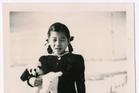 Japanese American girl with stuffed animal dog (ddr-densho-362-30)