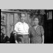 Man and woman standing by fence (ddr-densho-426-1123)