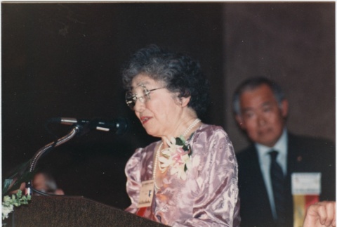 Mary Tsukamoto speaking at the 1986 JACL National Convention kickoff dinner (ddr-densho-10-33)