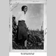 Woman leaning against woodpile (ddr-ajah-6-100)