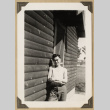 Lloyd Sato beside a cabin (ddr-densho-542-477)