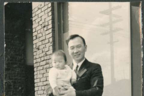Man holding baby (ddr-densho-523-55)