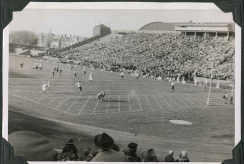 Football game in stadium with crowd in bleachers (ddr-ajah-2-511)
