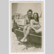 Man and woman sitting in boat on beach (ddr-densho-368-161)